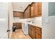 This well-equipped laundry room has custom cabinets, granite countertops, and modern washer and dryer appliances at 1508 N Alta Mesa Dr # 120, Mesa, AZ 85205