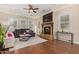 Bright living room with hardwood floors, a fireplace, and multiple windows at 1508 N Alta Mesa Dr # 120, Mesa, AZ 85205