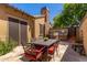Outdoor kitchen area with built-in grill, stone chimney, and a table with seating at 1508 N Alta Mesa Dr # 120, Mesa, AZ 85205