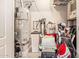 A well-organized storage area featuring a water heater, water softener, golf clubs, and storage shelves at 1508 N Alta Mesa Dr # 120, Mesa, AZ 85205