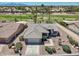 An aerial view of a single-Gathering home showcases the well-kept desert landscape and nearby golf course at 15371 W Piccadilly Rd, Goodyear, AZ 85395