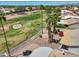 Backyard view overlooking the golf course, featuring a covered patio and lush greenery at 15371 W Piccadilly Rd, Goodyear, AZ 85395