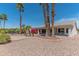 Backyard with palm trees and desert landscaping with a golf course view at 15371 W Piccadilly Rd, Goodyear, AZ 85395