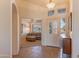 Inviting foyer with tile flooring, view into living room, and a bright front door at 15371 W Piccadilly Rd, Goodyear, AZ 85395