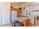 The kitchen features an island with seating and a door to the garage at 15371 W Piccadilly Rd, Goodyear, AZ 85395