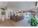 Bright living room featuring a large sectional sofa with views of the outdoor landscape at 15371 W Piccadilly Rd, Goodyear, AZ 85395