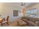 Cozy living room featuring a comfortable couch, ottoman, and a peaceful view at 15371 W Piccadilly Rd, Goodyear, AZ 85395