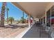 Covered patio with golf course views and an outdoor dining set at 15371 W Piccadilly Rd, Goodyear, AZ 85395