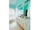Bright bathroom featuring double sinks, a large mirror, and a bathtub at 15897 N Gil Balcome St, Surprise, AZ 85374