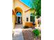 Inviting front entrance with an arched doorway and decorative landscaping at 15897 N Gil Balcome St, Surprise, AZ 85374