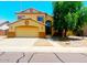 Charming two-story home with a well-manicured front yard and a two car garage at 15897 N Gil Balcome St, Surprise, AZ 85374