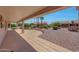 Spacious covered patio with desert landscaping offers an inviting outdoor living space at 16313 W Escondido Ct, Surprise, AZ 85374