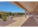 Expansive covered patio area overlooks a meticulously landscaped backyard with desert flora at 16313 W Escondido Ct, Surprise, AZ 85374