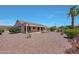 Home's backyard showcasing desert landscaping and a covered patio area, perfect for outdoor living at 16313 W Escondido Ct, Surprise, AZ 85374