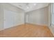 An empty bedroom features wood flooring, a large closet, and neutral walls at 16313 W Escondido Ct, Surprise, AZ 85374