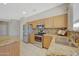 Well-lit kitchen featuring stainless steel appliances, stylish wood cabinets, and granite countertops at 16313 W Escondido Ct, Surprise, AZ 85374