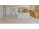 Kitchen with island, stainless steel fridge, and wood cabinets beneath recessed lighting at 16313 W Escondido Ct, Surprise, AZ 85374