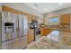 Spacious kitchen with stainless steel appliances, granite counters, and a refrigerator with water dispenser at 16313 W Escondido Ct, Surprise, AZ 85374