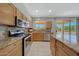 Open kitchen boasts granite countertops, stainless steel appliances, and backyard views at 16313 W Escondido Ct, Surprise, AZ 85374