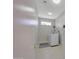 Bright laundry room features a modern washing machine, tile flooring, and convenient shelving at 16313 W Escondido Ct, Surprise, AZ 85374