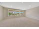 Spacious living room with large windows offering an abundance of natural light and exterior views at 16313 W Escondido Ct, Surprise, AZ 85374
