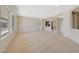 Expansive living room with neutral tones, carpet flooring, and ample space for furnishings at 16313 W Escondido Ct, Surprise, AZ 85374