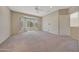 Spacious main bedroom with plush carpeting, a ceiling fan, and a large bay window at 16313 W Escondido Ct, Surprise, AZ 85374