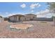 Large backyard featuring gravel landscaping, a small patch of artificial turf, and block fencing at 1652 E Judi St, Casa Grande, AZ 85122