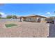 Gravel backyard features block fencing, a small patch of artificial turf, and a covered patio at 1652 E Judi St, Casa Grande, AZ 85122