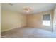Simple bedroom with carpet, window with blinds, and overhead ceiling fan at 1652 E Judi St, Casa Grande, AZ 85122