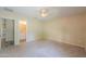 Bedroom with carpeted floor, adjoining door to bathroom and overhead ceiling fan at 1652 E Judi St, Casa Grande, AZ 85122