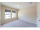 A well-lit bedroom with neutral walls, carpet flooring, and large windows offering natural light at 1652 E Judi St, Casa Grande, AZ 85122