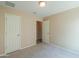 Neutral bedroom featuring carpeted floors, two doors, and a simple ceiling light fixture at 1652 E Judi St, Casa Grande, AZ 85122