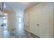 Hallway with gray wood-look floors, leading to living area, and large closet with double doors at 1652 E Judi St, Casa Grande, AZ 85122