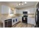 Kitchen with white cabinets, gray countertops, stainless steel appliances, and wood-look floor at 1652 E Judi St, Casa Grande, AZ 85122