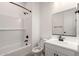 Elegant bathroom with subway tiled shower and modern hardware paired with a white single sink vanity at 18174 W Ashley Dr, Goodyear, AZ 85338