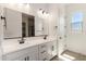 Elegant bathroom featuring a double sink vanity with sleek hardware and a framed mirror for elevated style at 18174 W Ashley Dr, Goodyear, AZ 85338