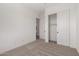 Bedroom with closet featuring sliding doors and neutral colored carpet at 18174 W Ashley Dr, Goodyear, AZ 85338