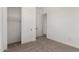 Bedroom with closet featuring sliding doors and neutral colored carpet at 18174 W Ashley Dr, Goodyear, AZ 85338