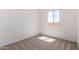 Bright bedroom with a window showing exterior light and neutral carpet at 18174 W Ashley Dr, Goodyear, AZ 85338