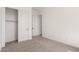 Bedroom with closet featuring sliding doors and neutral colored carpet at 18174 W Ashley Dr, Goodyear, AZ 85338