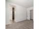 Spacious bedroom with an ensuite bath and large doors, features neutral carpet and bright white walls at 18174 W Ashley Dr, Goodyear, AZ 85338