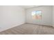 Bright bedroom with a large window and neutral carpet, offering a serene and comfortable space at 18174 W Ashley Dr, Goodyear, AZ 85338