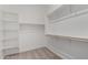 Spacious walk-in closet showcasing abundant shelving for storage solutions, and neutral carpet at 18174 W Ashley Dr, Goodyear, AZ 85338