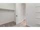Well-organized closet with neutral carpet and shelving, designed for efficient storage and convenience at 18174 W Ashley Dr, Goodyear, AZ 85338