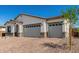 Home exterior with 3 car garage and brick paver driveway at 18174 W Ashley Dr, Goodyear, AZ 85338