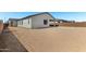 Home exterior with desert landscaping and view of covered patio at 18174 W Ashley Dr, Goodyear, AZ 85338