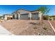 Home exterior with 3 car garage and brick paver driveway at 18174 W Ashley Dr, Goodyear, AZ 85338