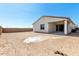 Home exterior with desert landscaping, covered patio, and brick fencing at 18174 W Ashley Dr, Goodyear, AZ 85338