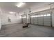 Spacious garage with two overhead doors and a utility water heater at 18174 W Ashley Dr, Goodyear, AZ 85338